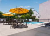 Thumbnail 31 of 50 - our apartments have a pool and a patio with chairs and umbrellas