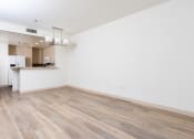 Thumbnail 39 of 50 - an empty living room with white walls and wood flooring