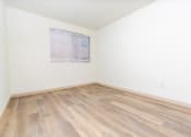 Thumbnail 46 of 50 - an empty room with wood floors and a window