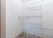 Thumbnail 48 of 50 - an empty closet with white walls and white wire shelves