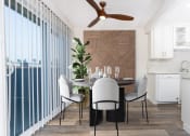 Thumbnail 31 of 77 - a dining room with a table and chairs and a ceiling fan