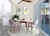 Thumbnail 49 of 77 - a dining room with a round table and pink chairs