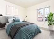 Thumbnail 50 of 77 - a bedroom with two windows and a bed with green sheets