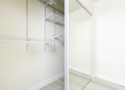 Thumbnail 53 of 77 - two views of a mirrored closet in a bedroom with white walls and wood floors