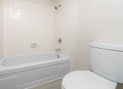 Thumbnail 55 of 77 - a bathroom with a toilet and a bath tub