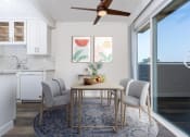 Thumbnail 58 of 77 - a dining area with a table and chairs and a ceiling fan