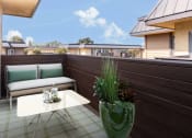 Thumbnail 57 of 77 - a balcony with a couch and a table and a potted plant