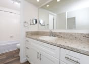 Thumbnail 61 of 77 - a bathroom with a sink and a toilet and a mirror
