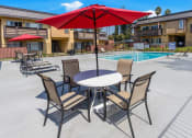 Thumbnail 63 of 77 - our apartments have a patio with a table and chairs and a pool