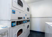 Thumbnail 76 of 77 - a washer and dryer in a laundry room with white walls