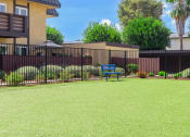 Thumbnail 68 of 77 - a blue bench sitting in the middle of a lush green yard