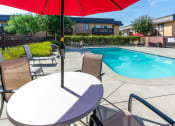 Thumbnail 17 of 77 - resident pool with lounge seating and umbrellas