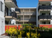 Thumbnail 21 of 36 - an image of an apartment building with balconies and flowers