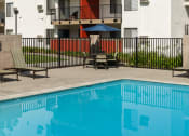 Thumbnail 13 of 36 - a building with a swimming pool in front of it