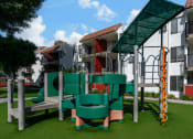 Thumbnail 18 of 36 - a playground with a building in the background