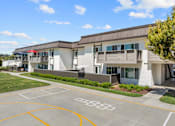Thumbnail 77 of 91 - A building with a basketball court in front of it.