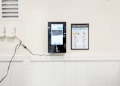 Thumbnail 37 of 91 - Two tablets are plugged into a wall socket.