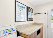 Thumbnail 36 of 91 - A laundry room with a washer and dryer.
