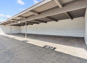 Thumbnail 83 of 91 - A parking garage with a concrete floor and a white wall.