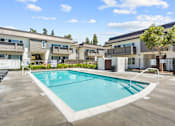 Thumbnail 51 of 91 - A swimming pool in a sunny day surrounded by apartment buildings.