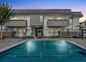 Thumbnail 90 of 91 - A modern house with a pool in front.