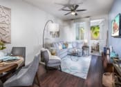 Thumbnail 24 of 62 - One BR Apartments in Chino Hills, CA - Capriana at Chino Hills - Spacious Living Room with Wood-Look Plank Floors, a Ceiling Fan, and Door to Balcony at Capriana at Chino Hills, Chino Hills, CA, 91709