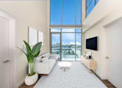 Thumbnail 47 of 127 - A modern living room with a large window and a flat screen TV mounted on the wall.