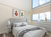Thumbnail 34 of 127 - A bedroom with a large bed and two framed pictures on the wall.
