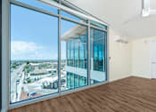Thumbnail 32 of 127 - A room with a view of the street outside through large windows.