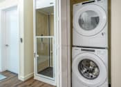 Thumbnail 38 of 127 - A white washing machine is stacked on top of another white washing machine.