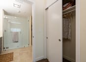 Thumbnail 37 of 127 - A bathroom with a walk-in shower and a white door.