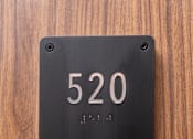 Thumbnail 24 of 127 - A black door plate with the number 520 on it.