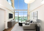 Thumbnail 28 of 127 - A modern living room with a large window and a flat screen TV.