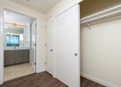 Thumbnail 17 of 127 - A white door is open to a room with a wooden floor.
