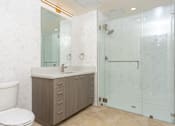 Thumbnail 16 of 127 - A bathroom with a toilet, sink, and shower.
