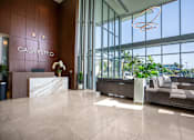 Thumbnail 6 of 127 - The image shows the lobby of a hotel named Casa Estilo with a reception desk and a sofa.