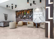 Thumbnail 8 of 127 - A modern living room with a grey sofa, a wooden bookshelf, and a marble wall.