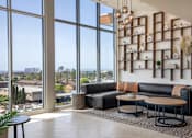 Thumbnail 9 of 127 - A living room with a large window overlooking a cityscape.