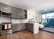 Thumbnail 59 of 127 - A modern kitchen with a stainless steel oven and a white refrigerator.