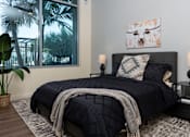 Thumbnail 66 of 127 - A bedroom with a large bed and a painting on the wall.