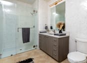 Thumbnail 68 of 127 - A bathroom with a toilet, sink, and shower.