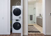 Thumbnail 67 of 127 - A white washing machine and dryer in a laundry room.