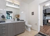 Thumbnail 15 of 127 - A bathroom with a white toilet and a grey cabinet.