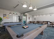 Thumbnail 77 of 127 - A pool table with a green cloth and a set of balls in the middle.