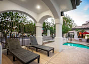 Thumbnail 8 of 48 - Two lounge chairs are placed under a white arched structure.