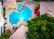 Thumbnail 9 of 48 - A swimming pool surrounded by a tiled roof and trees.