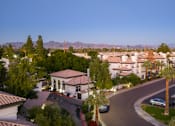 Thumbnail 10 of 48 - A residential area with houses and palm trees.