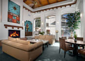 Thumbnail 12 of 48 - A living room with a fireplace and a couch.
