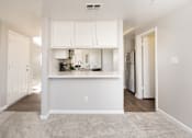 Thumbnail 21 of 48 - A kitchen area with white cabinets and appliances.