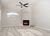 Thumbnail 25 of 48 - A living room with a fireplace and a fan.